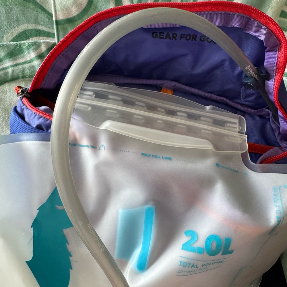 Cotopaxi 2L purple hydro hip pack with red and orange accents. - Picture 4 of 4